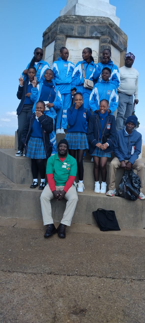 School group at a war memorial monument with guide